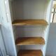 Shallow depth bookcase re-enchanted in pearl gray, wooden shelves.