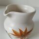 Vintage Marais pottery pitcher with orange floral decoration
