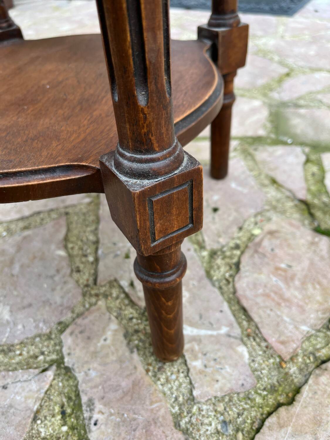 Old wooden pedestal table with marble top
