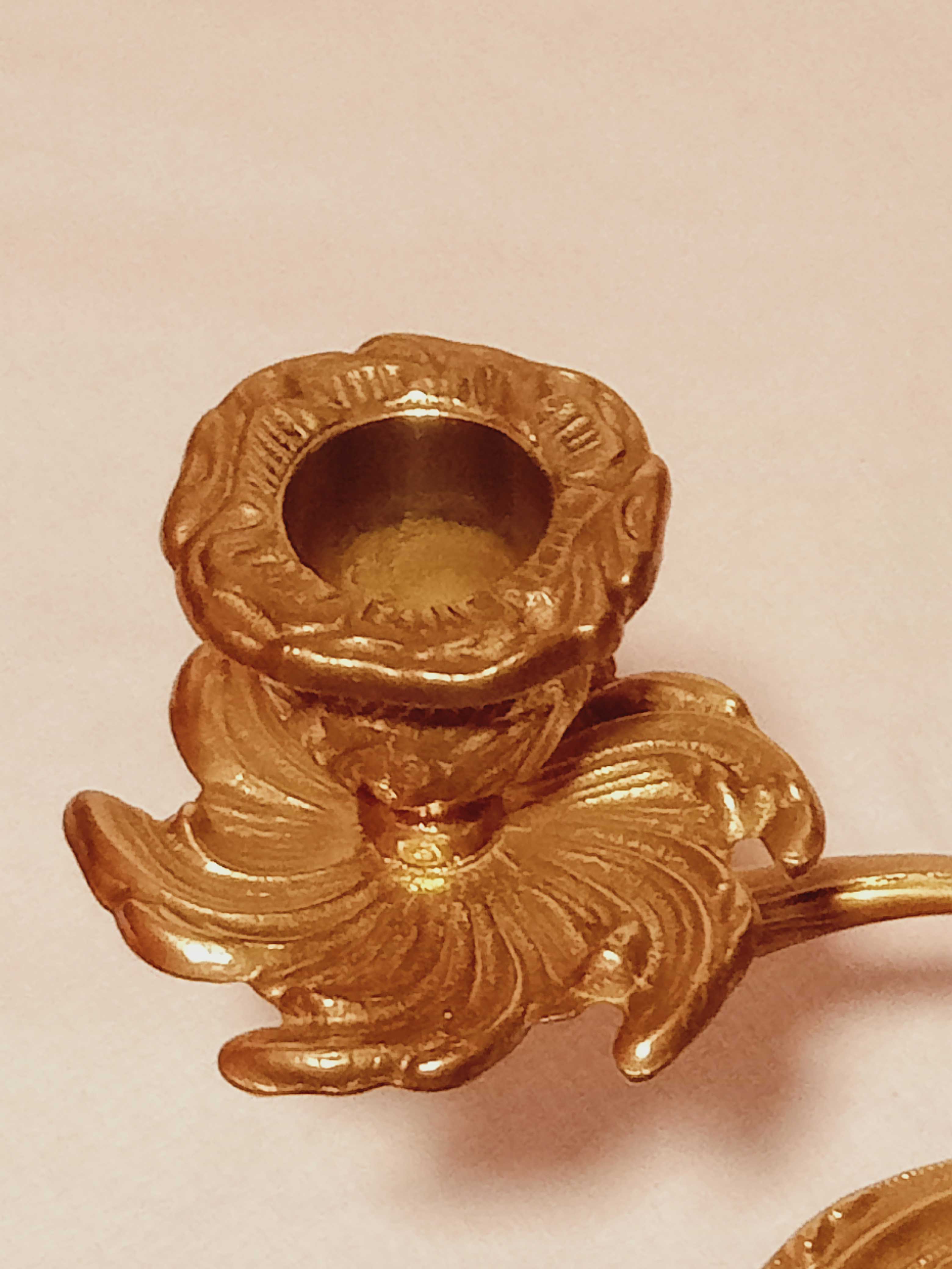 Old candle holder in gilded bronze