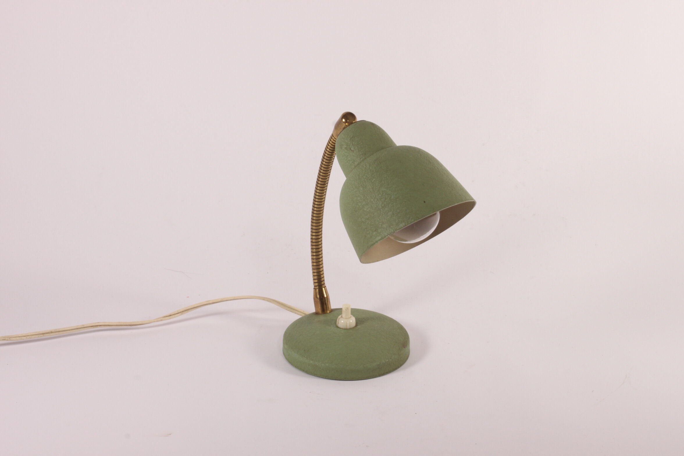 Flexible brass and green metal bedside lamp, 1950s.