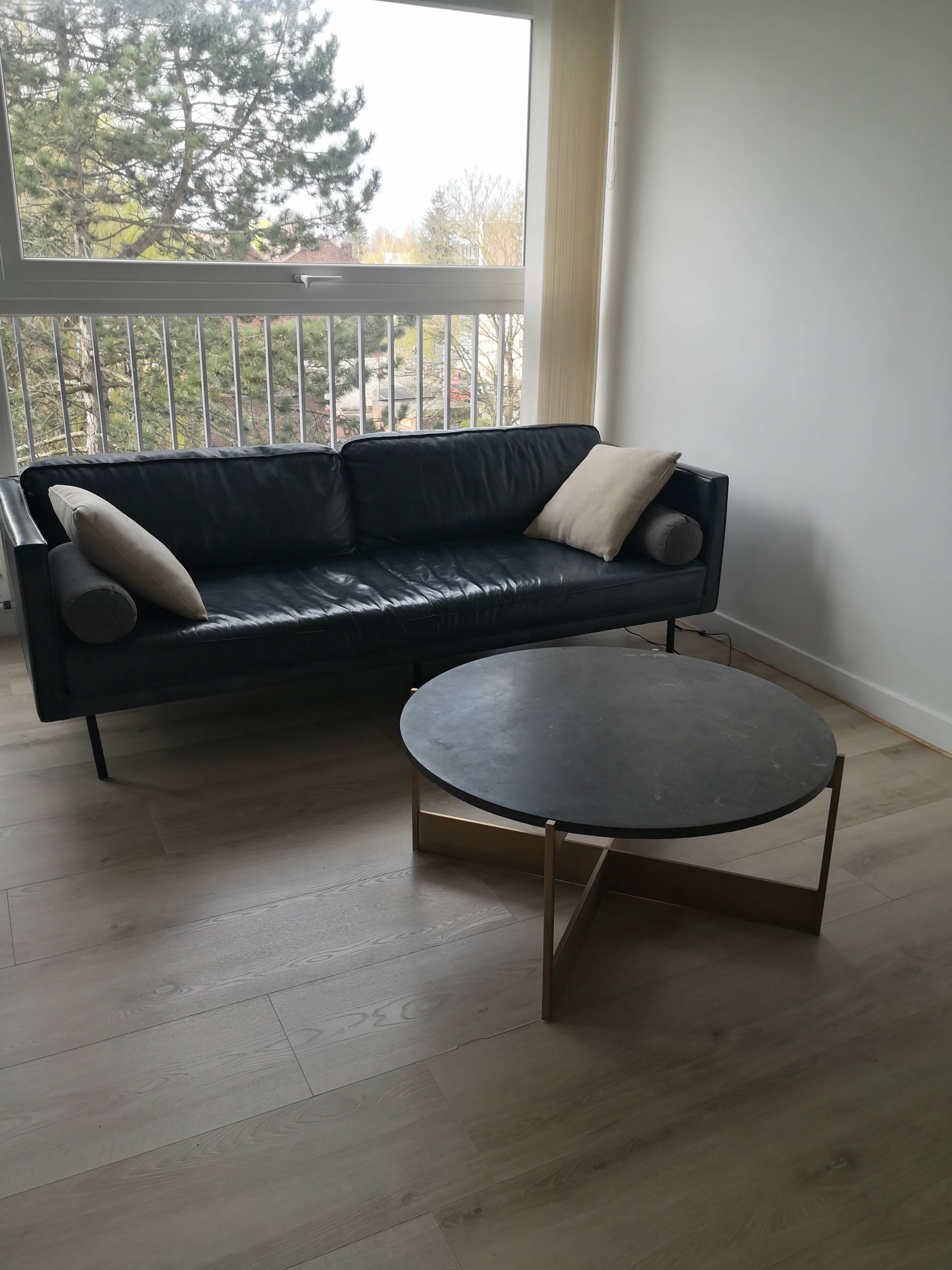Round coffee table with a metal base and a blue stone top.