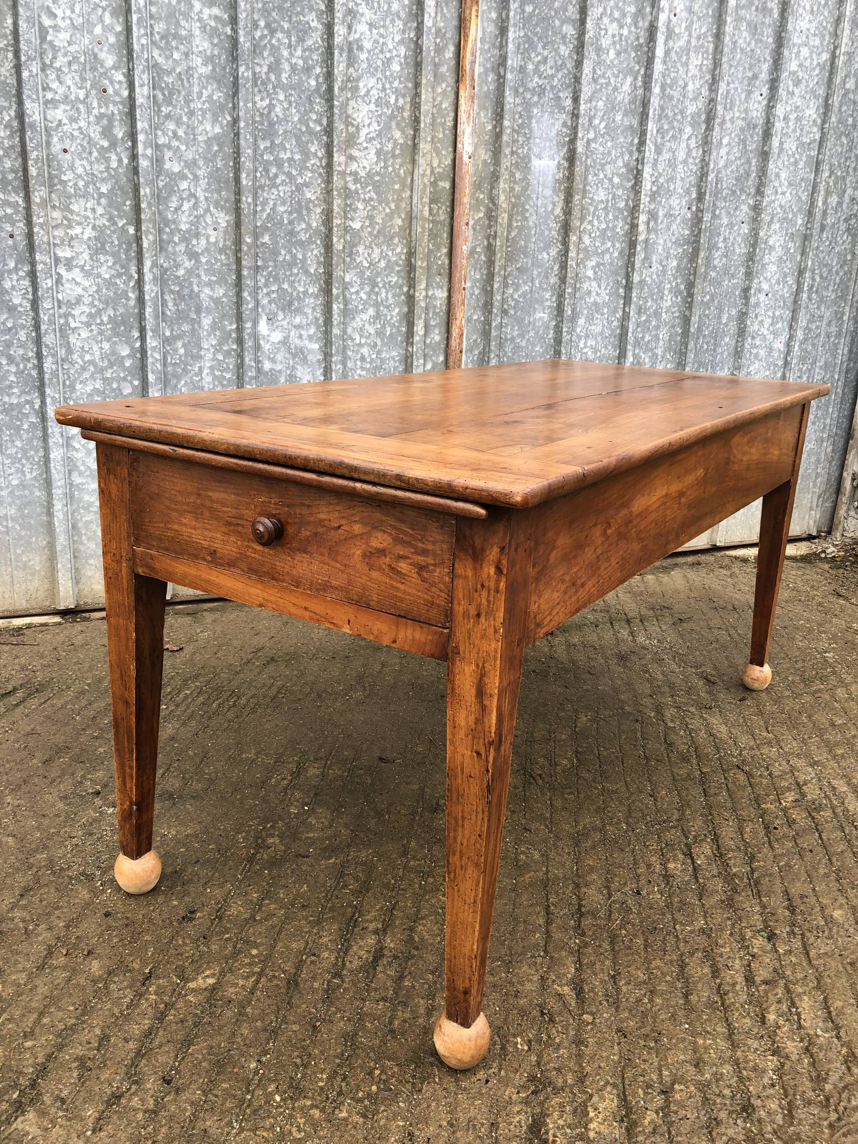 Antique solid cherry farmhouse table with 2 end drawers and 1 pull-out.