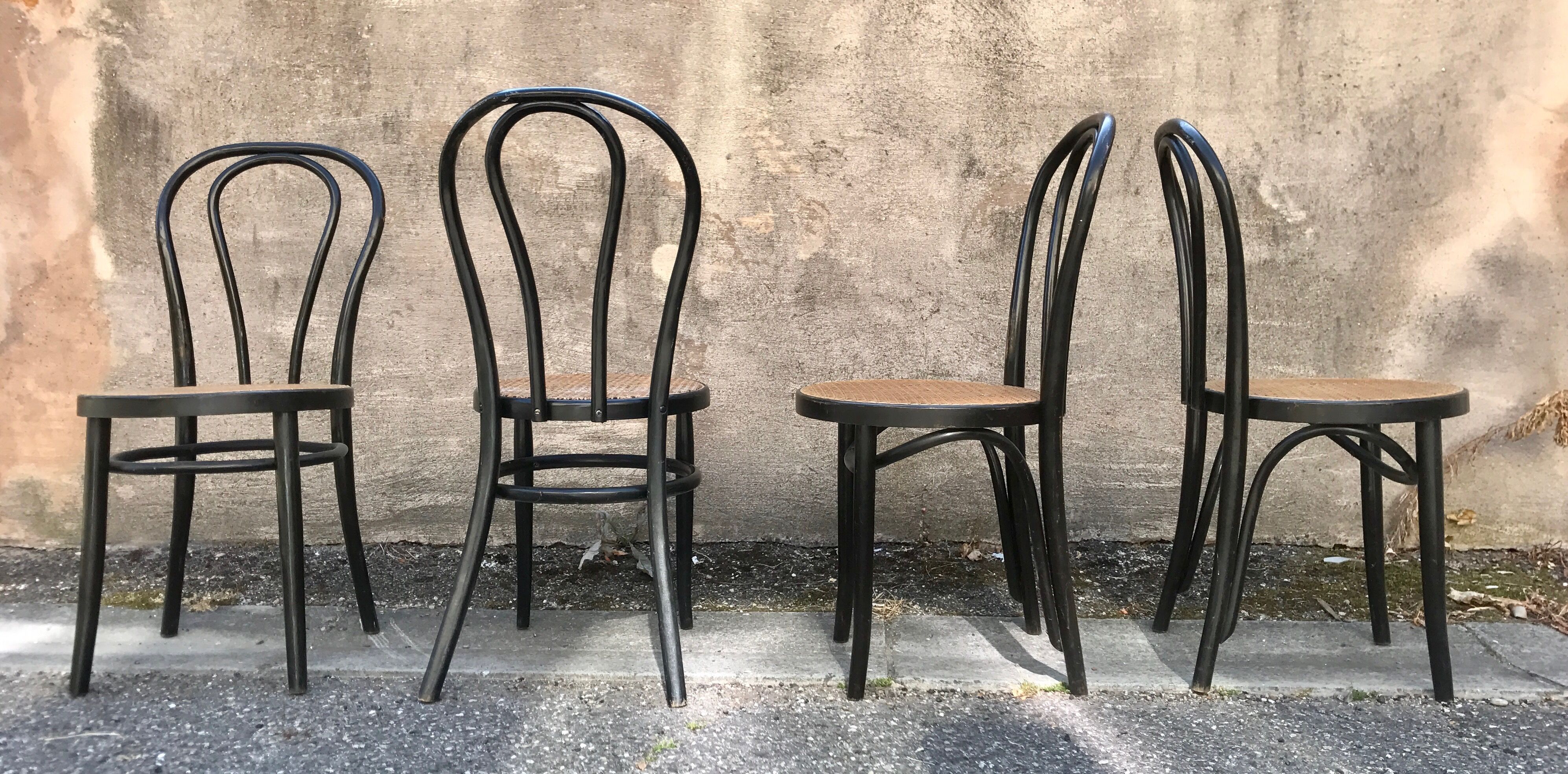 Two pairs of black 50s chairs - number 18 - cannée