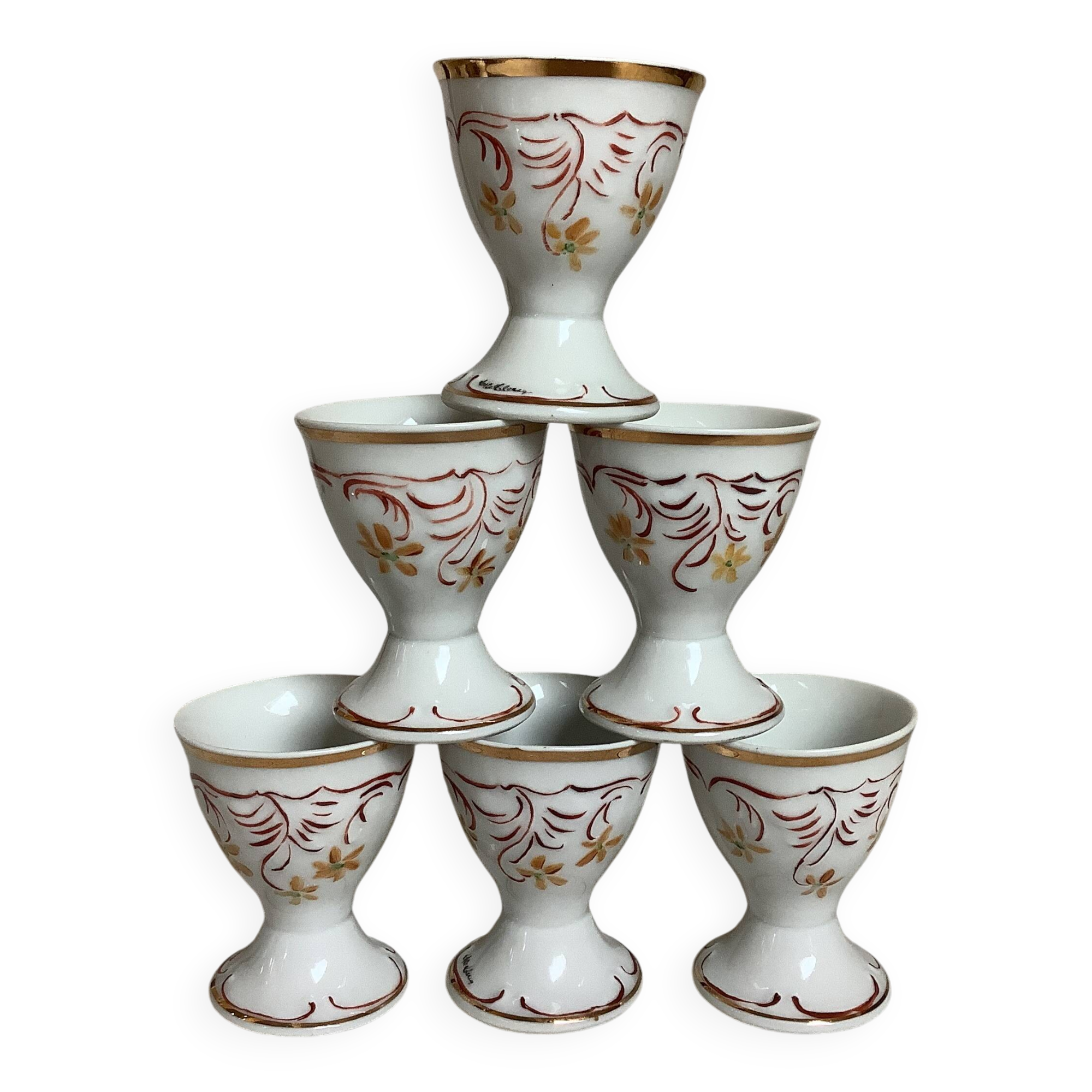 Six hand-decorated and signed egg cups