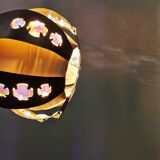 Hanging lamp in thin metal pieces, copper colored and black with prisms.