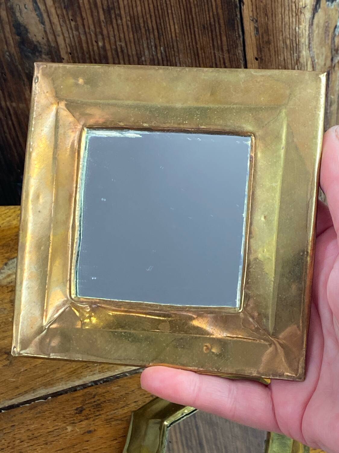 Set of five small wall mirrors in brass.