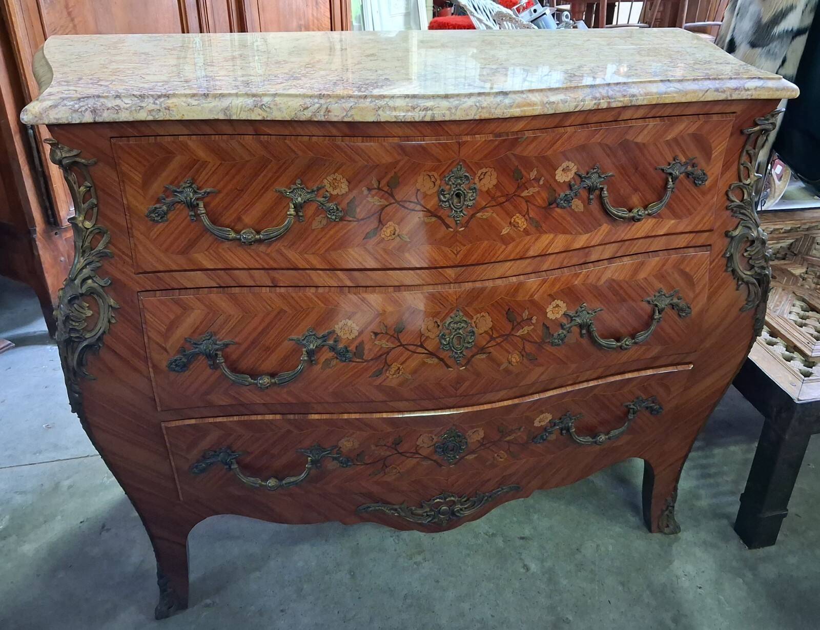 Curved Louis XV style commode with marquetry, opening with three drawers.