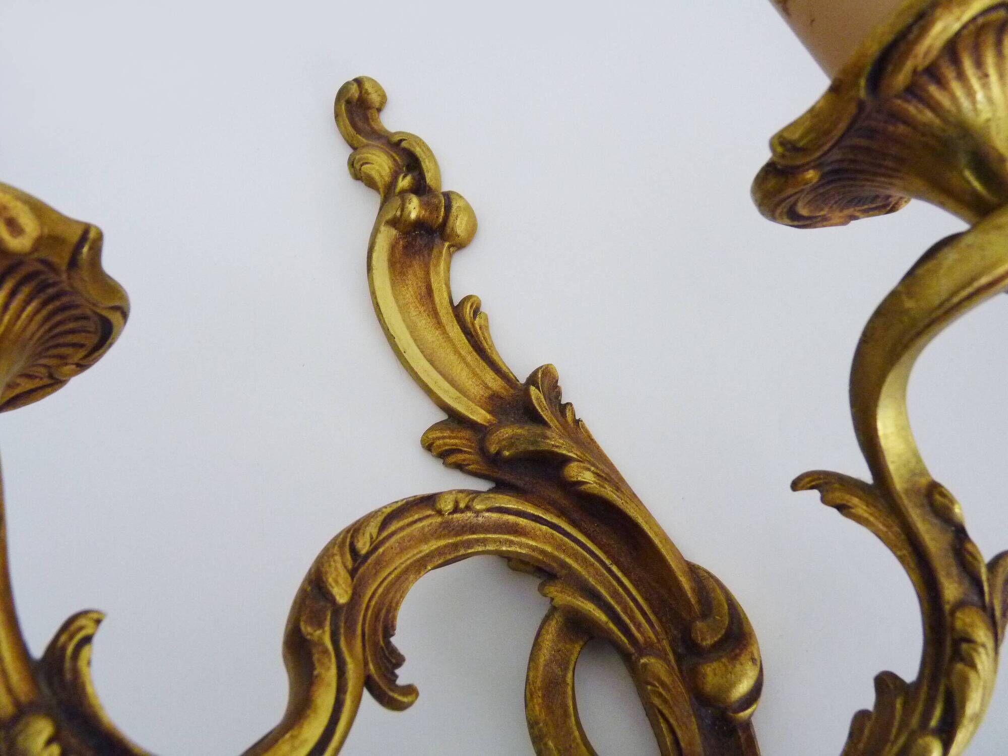 Antique pair of double-light bronze wall sconces with acanthus leaves. 1950s