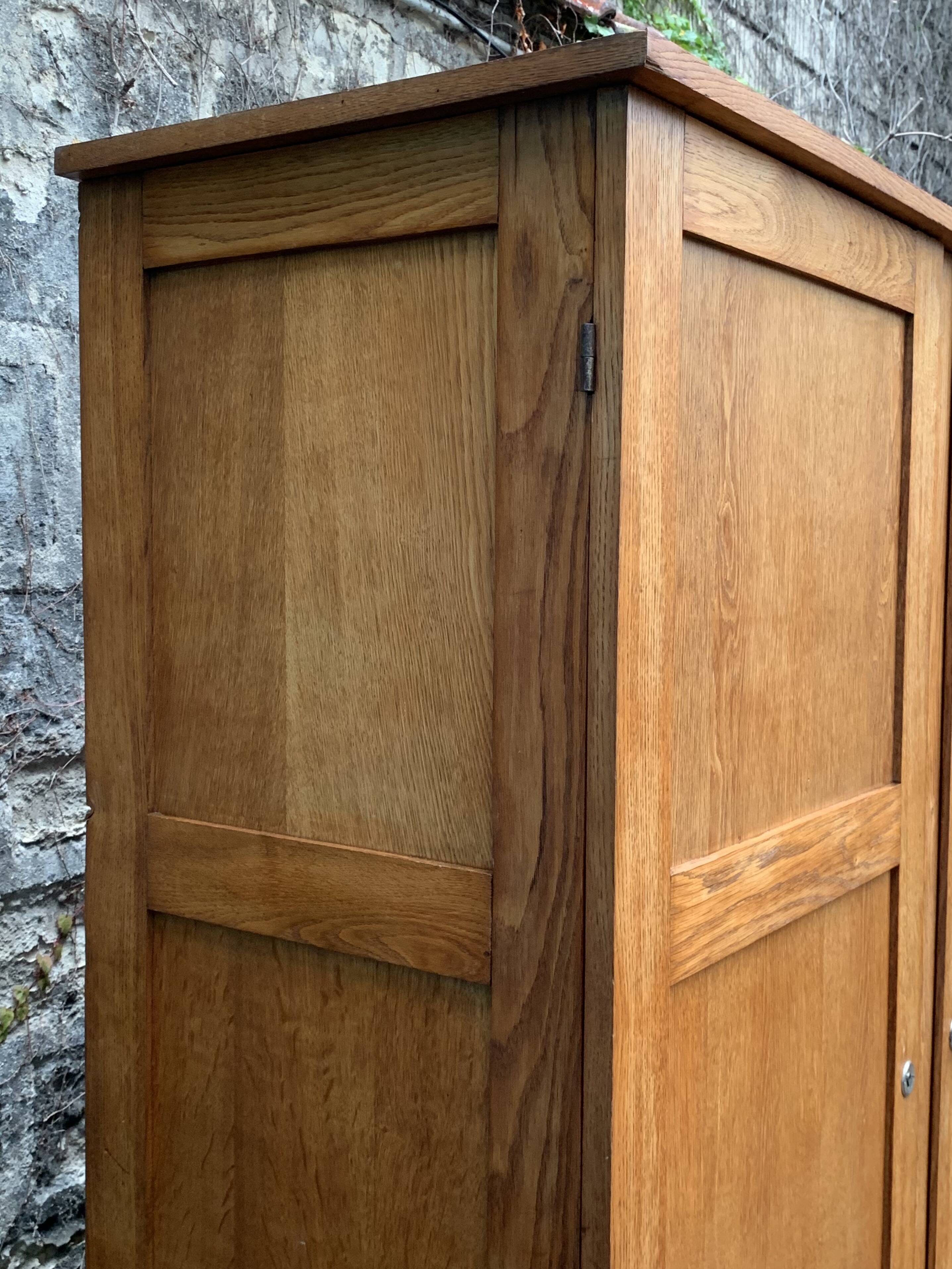 Solid oak compass foot cabinet René Gabriel 1945