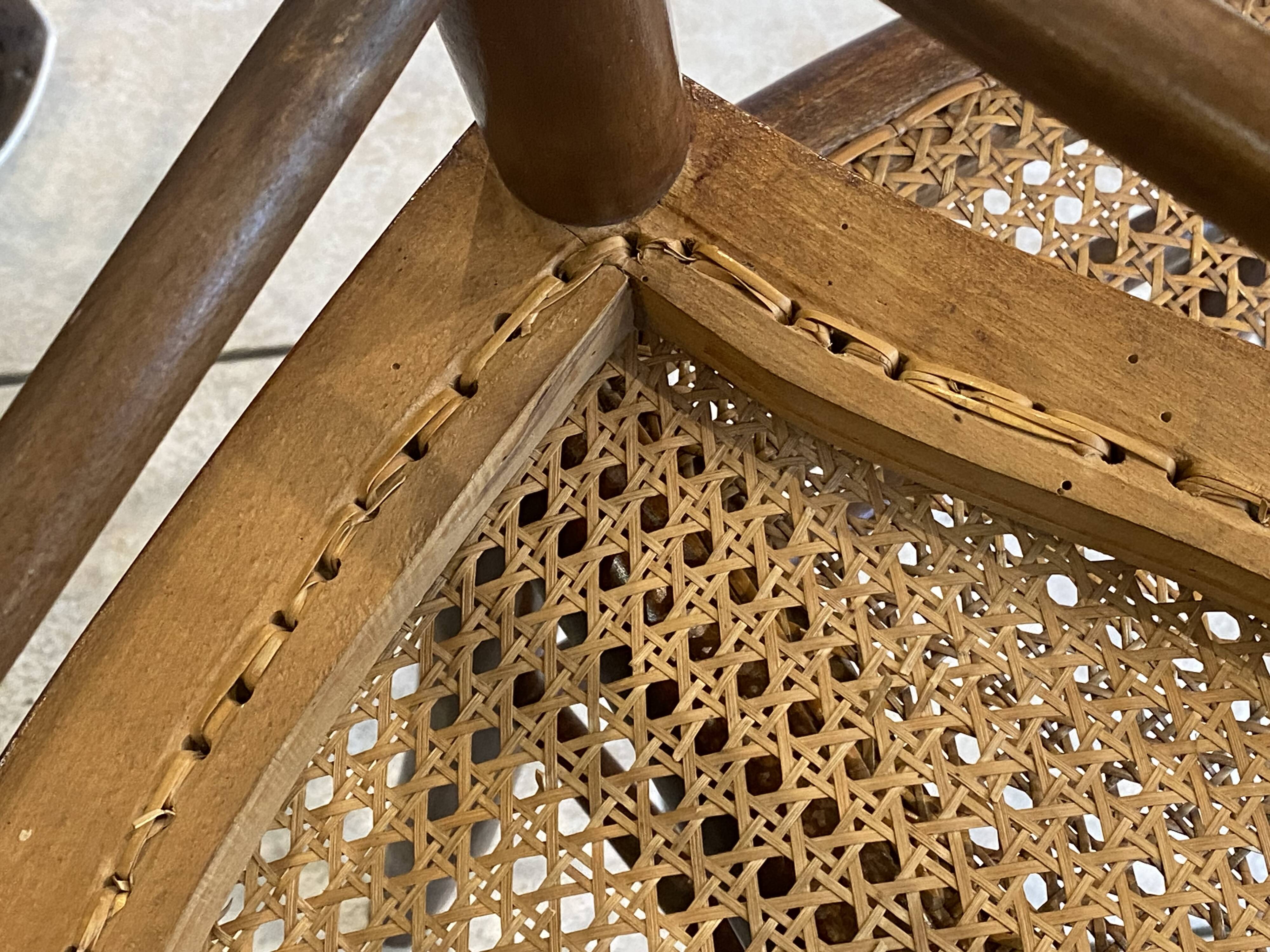Pair of antique caned and wooden chairs from the 1900s.