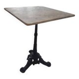 Bistro table with cast iron and white marble legs