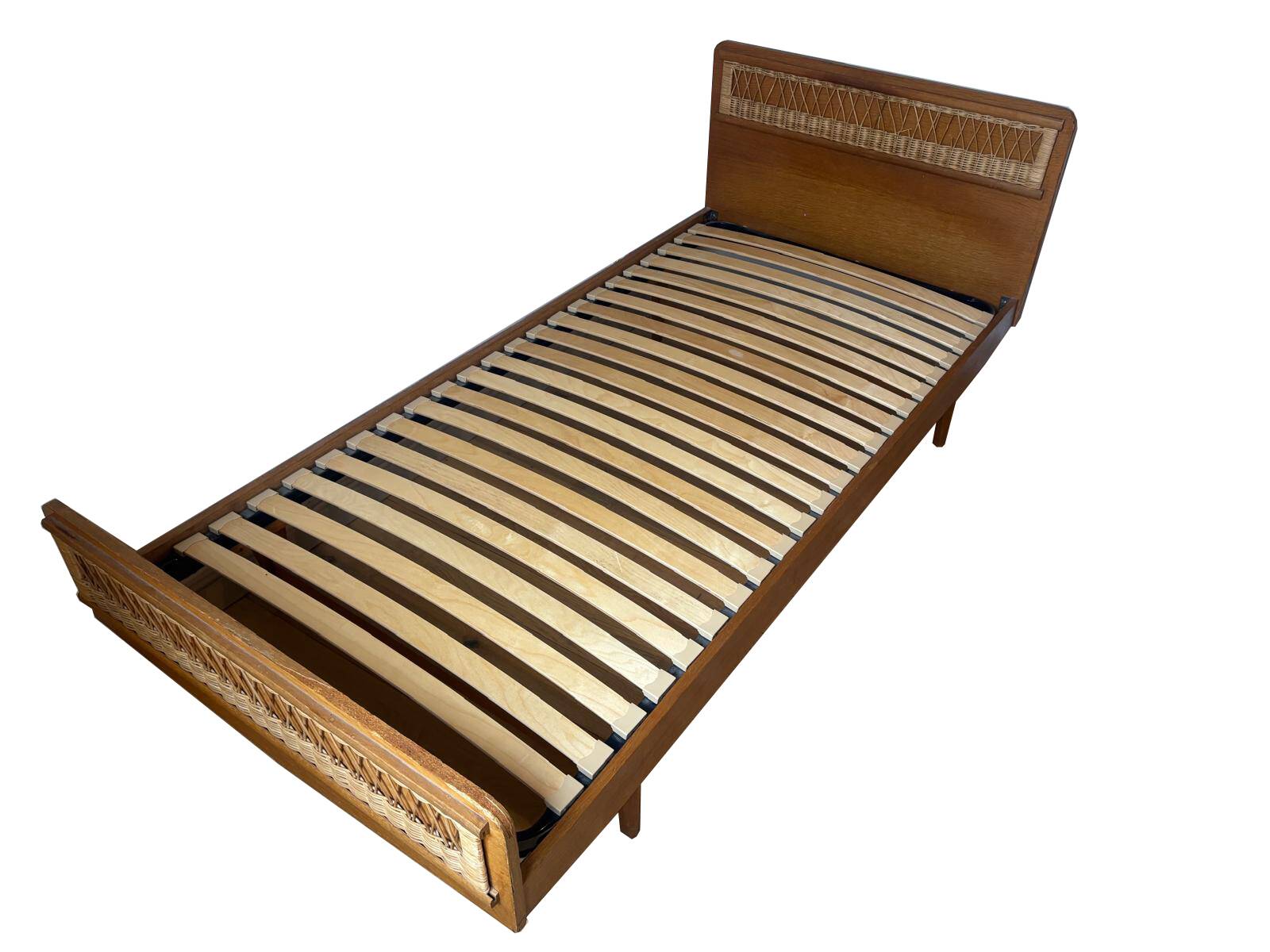 Vintage single bed made of rattan from the 1970s with a mattress.