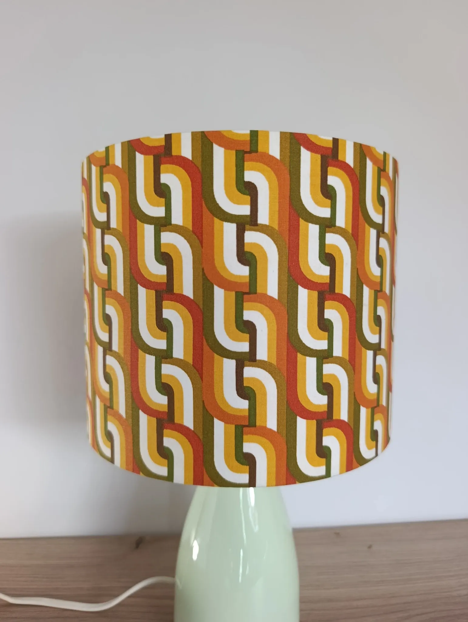 Seventies spirit lamp with geometric orange/green lampshade.