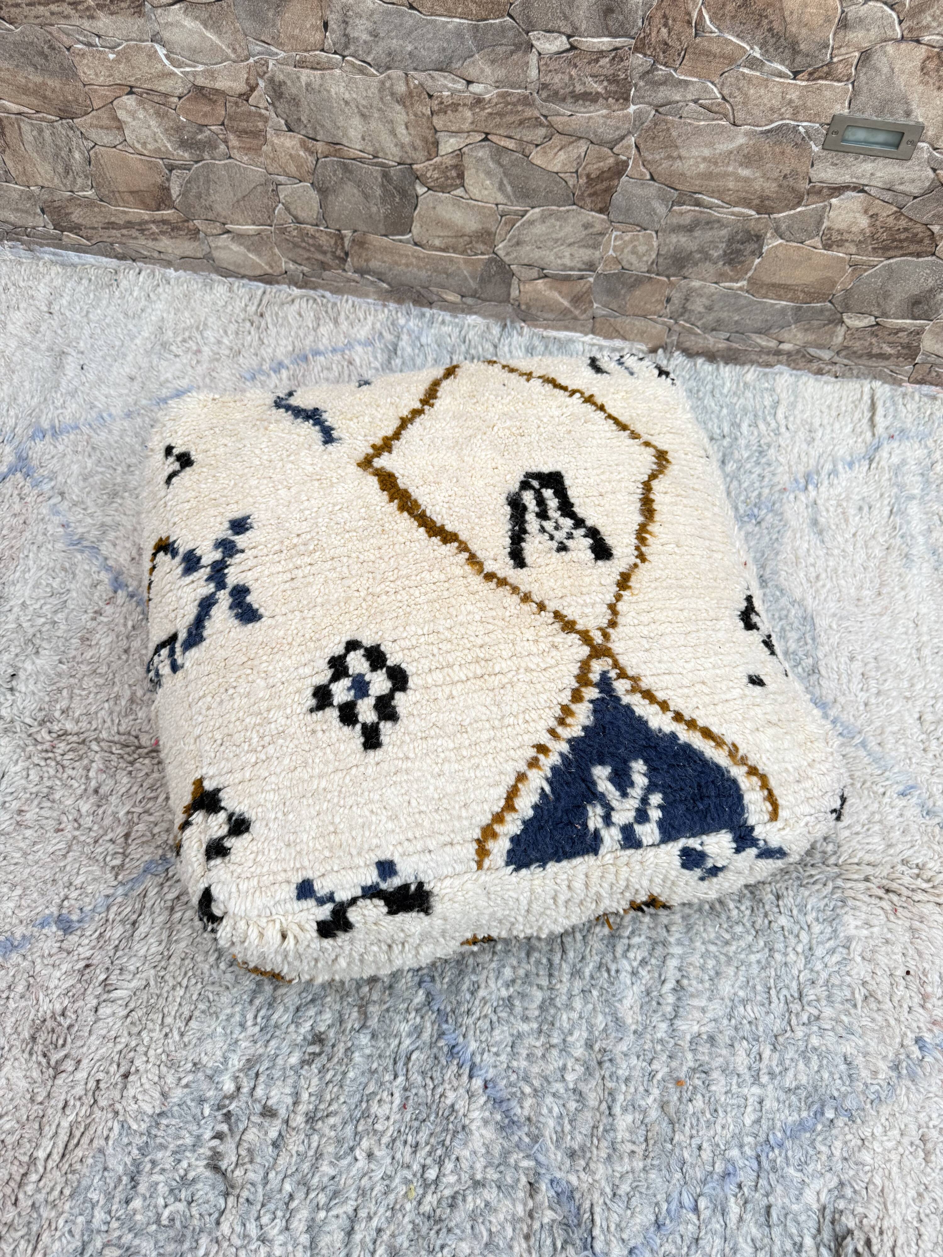 Berber floor pouf: Handwoven Moroccan wool cushion.