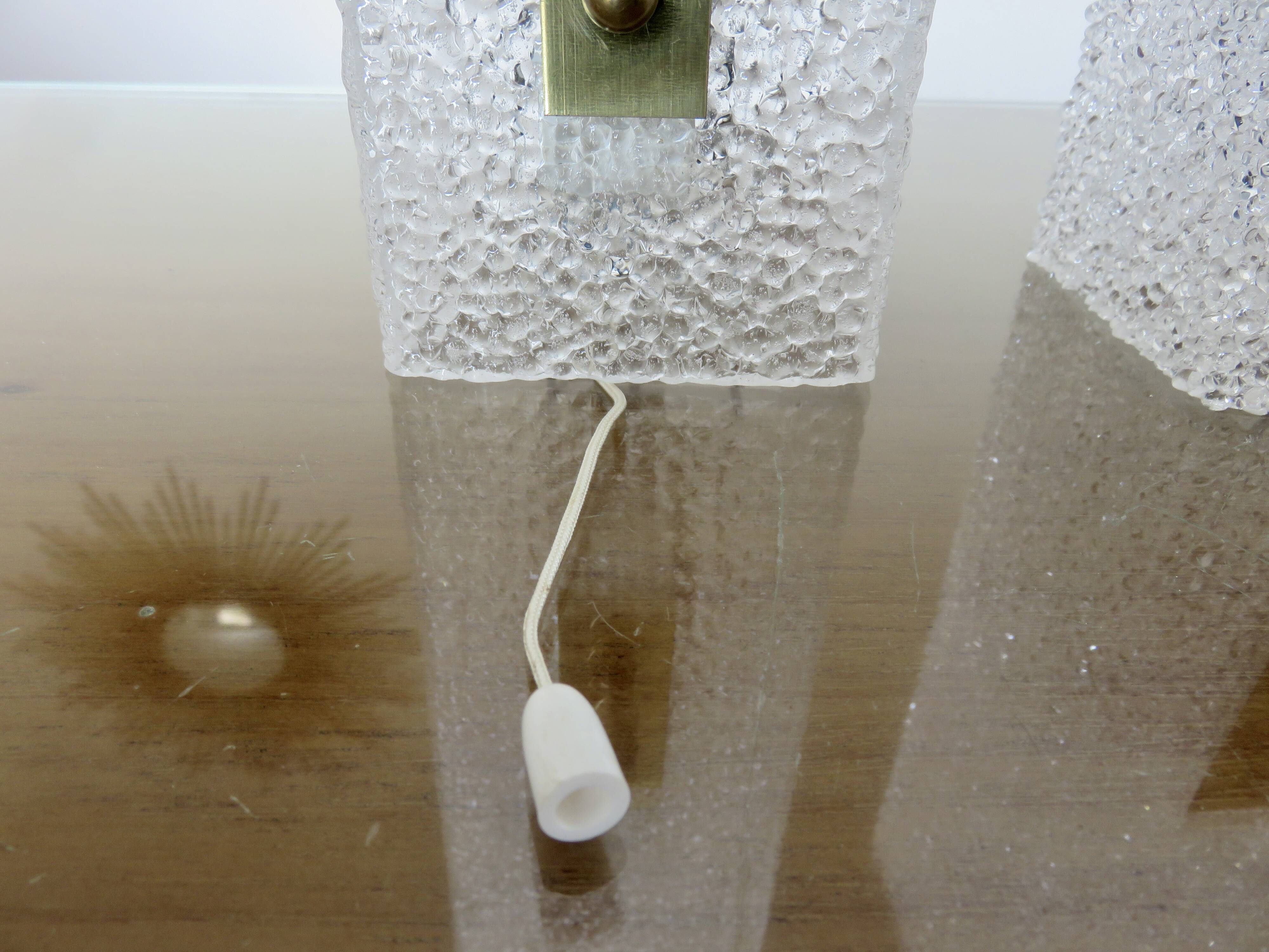 Pair of pull switch wall lights in perspex and gilded brass, France, circa 1960.
