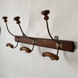 Antique wall-mounted coat rack in wood and metal