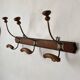Old wooden and metal wall-mounted coat rack.