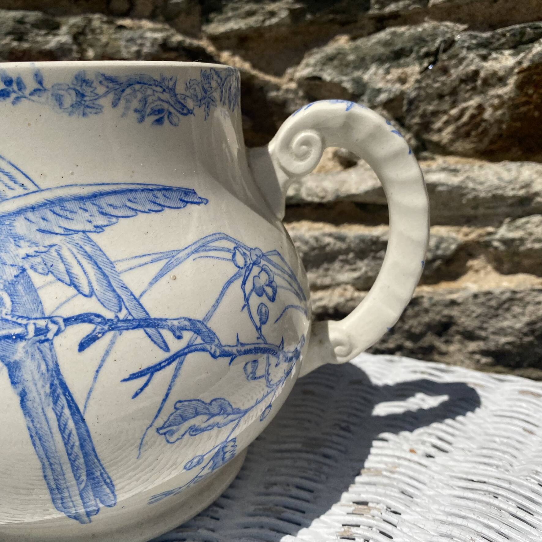 Earthenware pitcher decorated with birds.