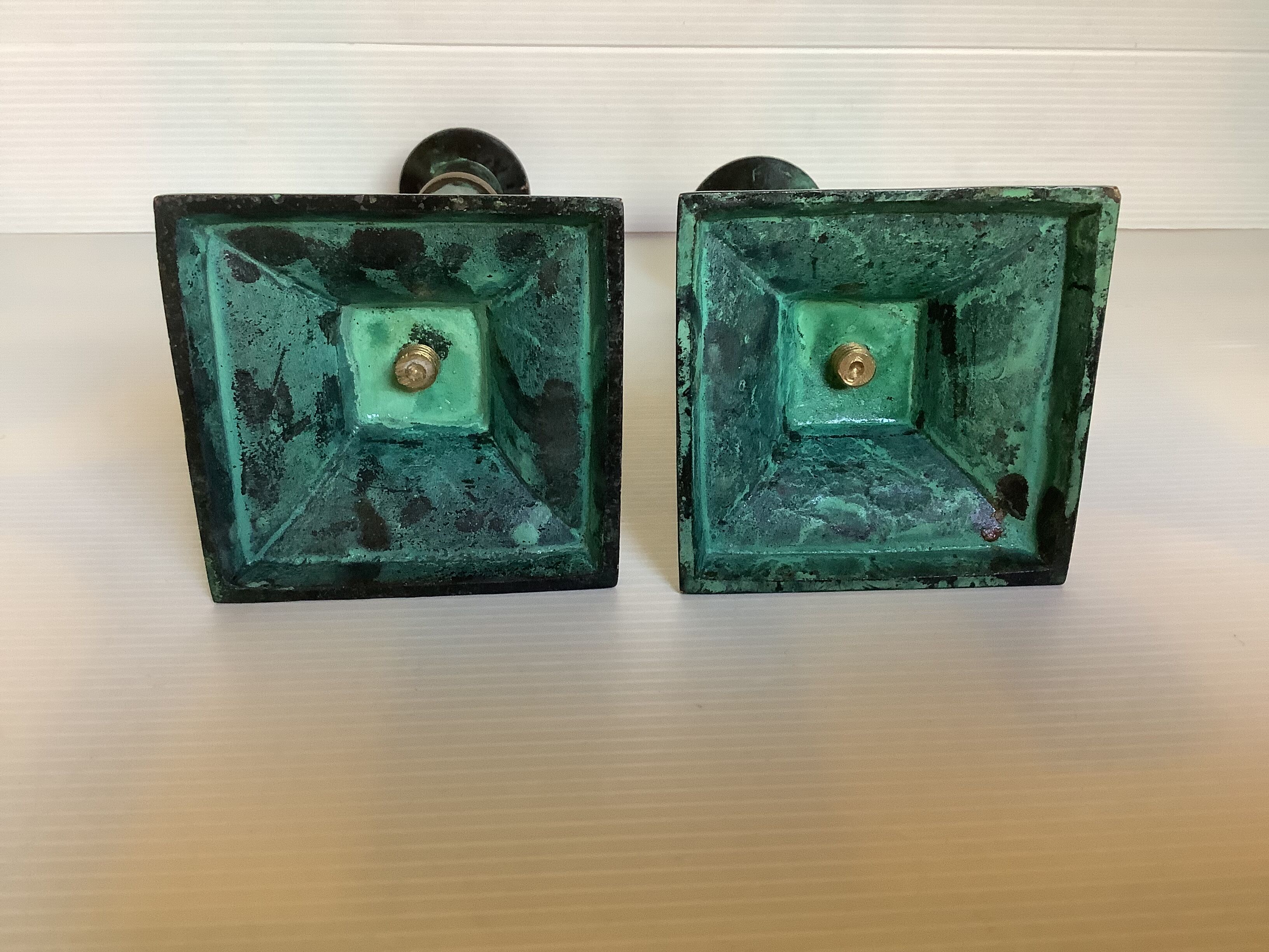 Pair of green patinated brass candlesticks