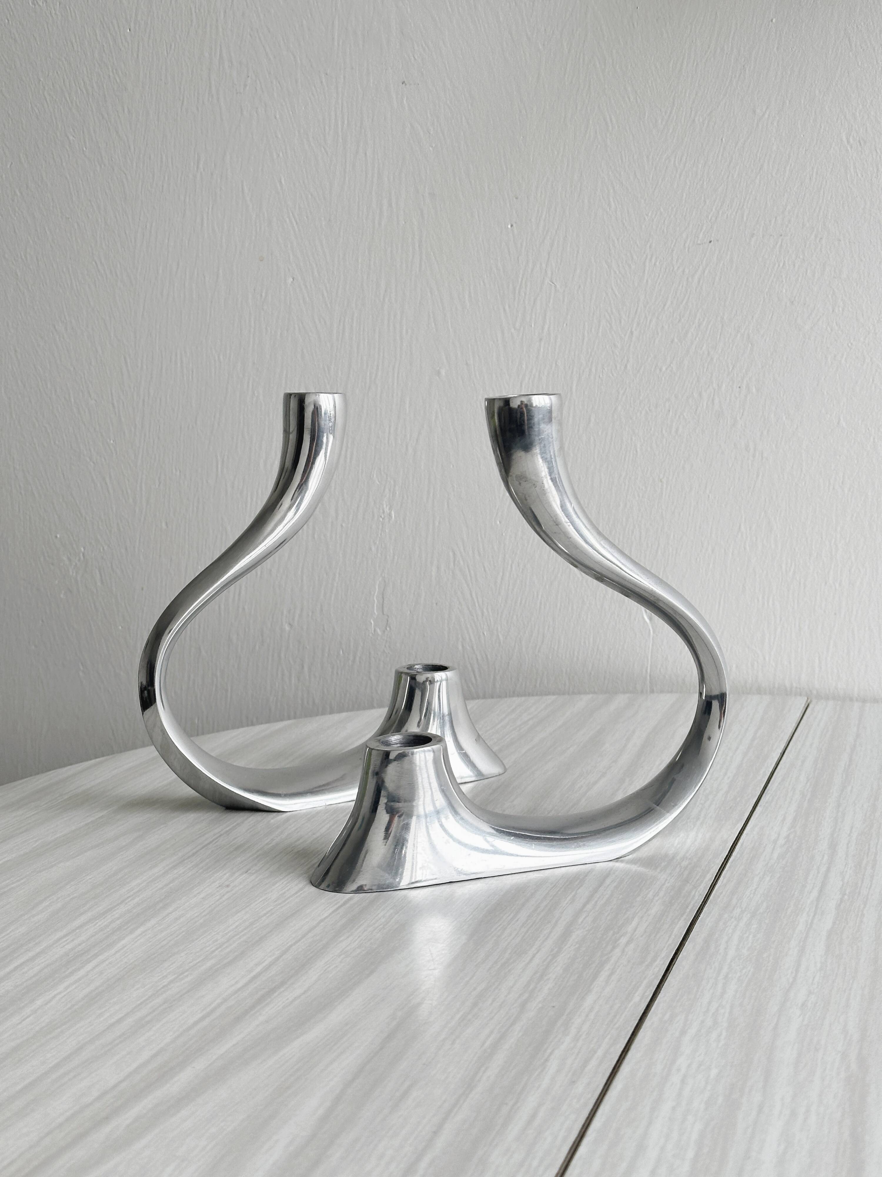 Pair of designer candlesticks in chromed metal