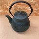 Old green cast iron Japanese teapot with flower decoration + vintage stand