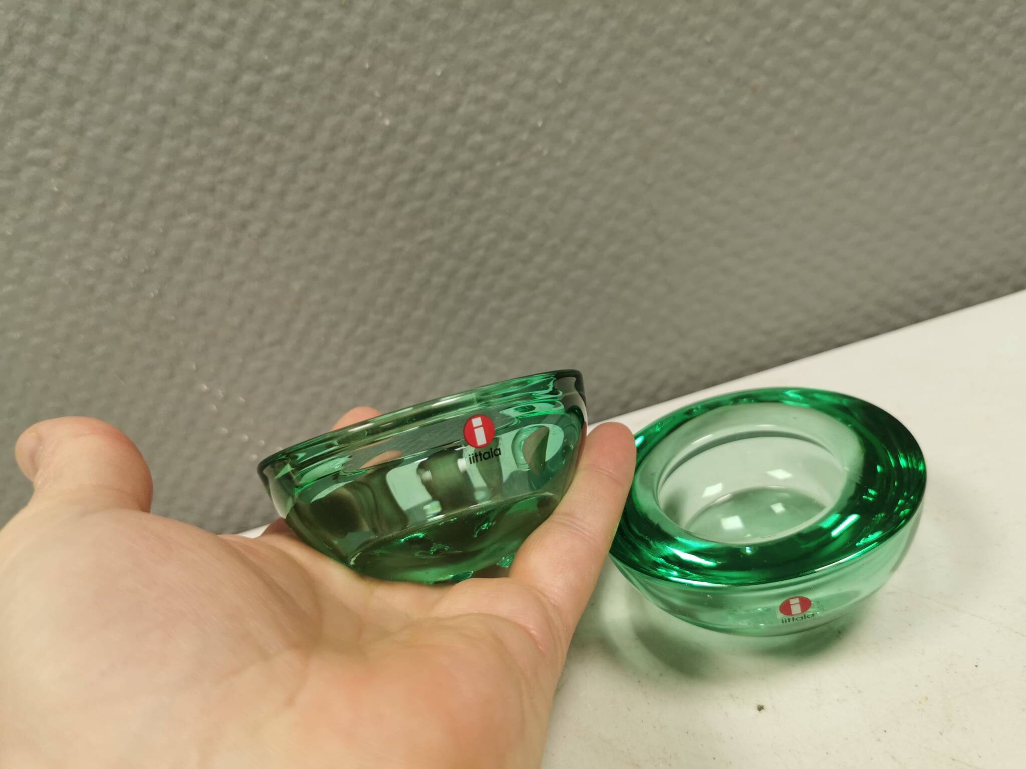 A set of iitalla candle holders in green transparent glass.
