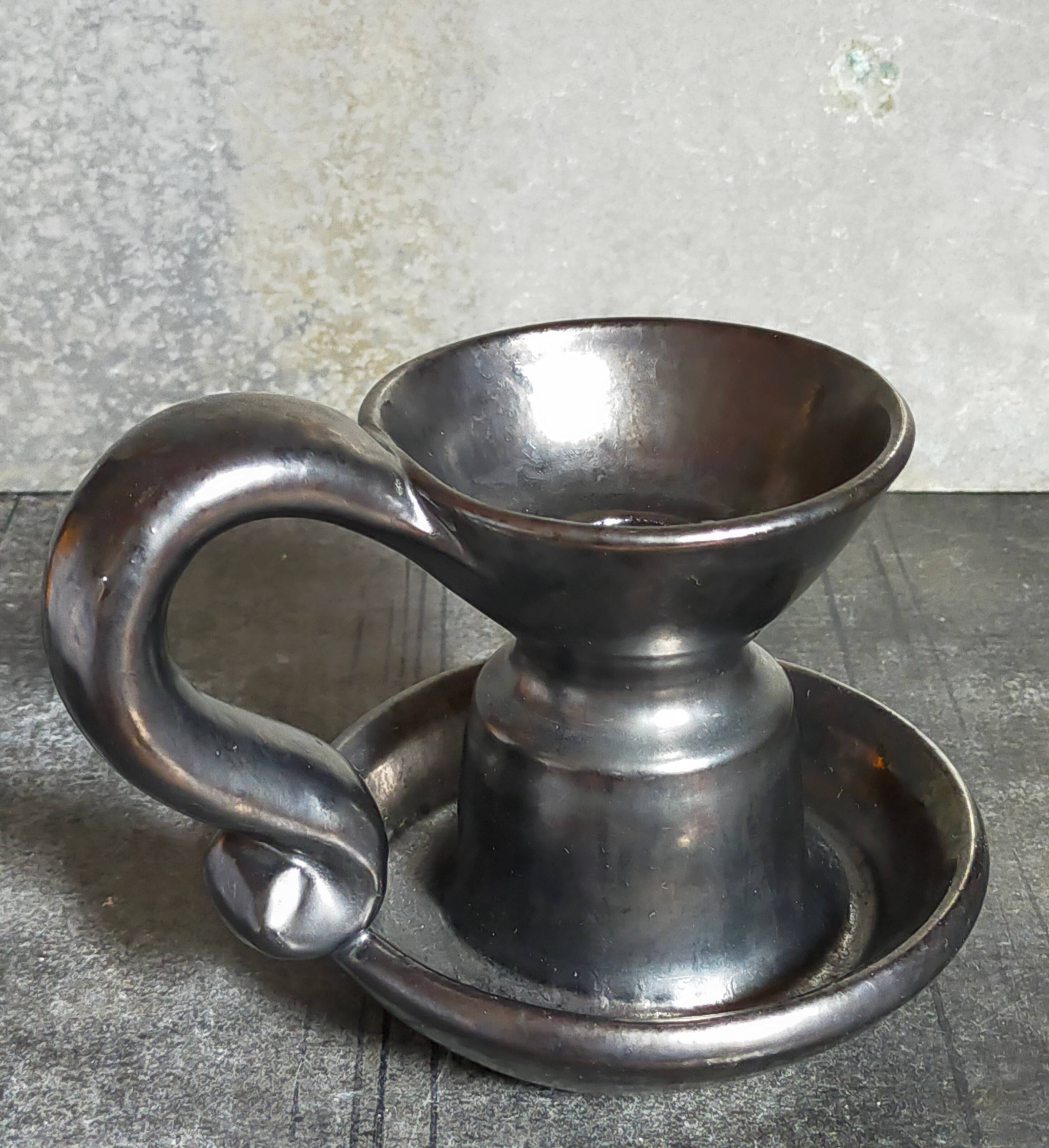 1950s iridescent black ceramic hand candle holder