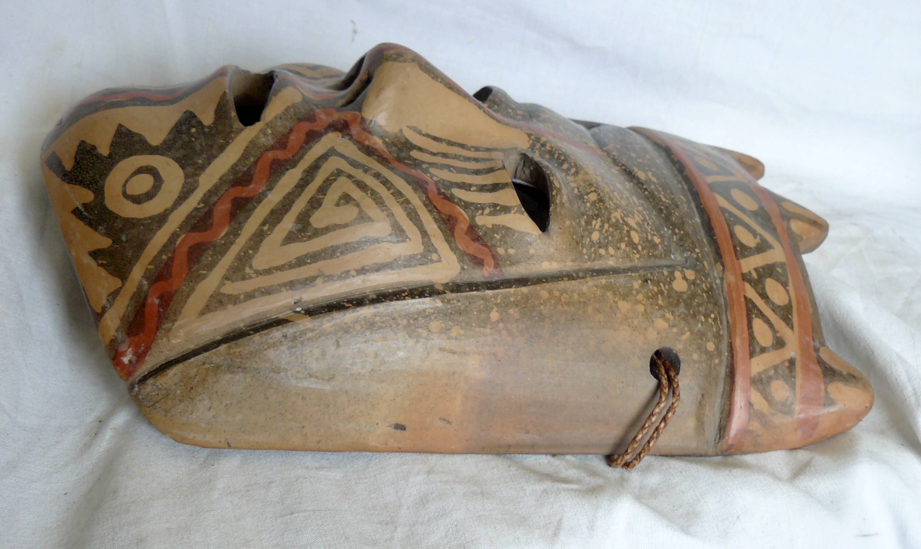 Terracotta mask with geometric decorations