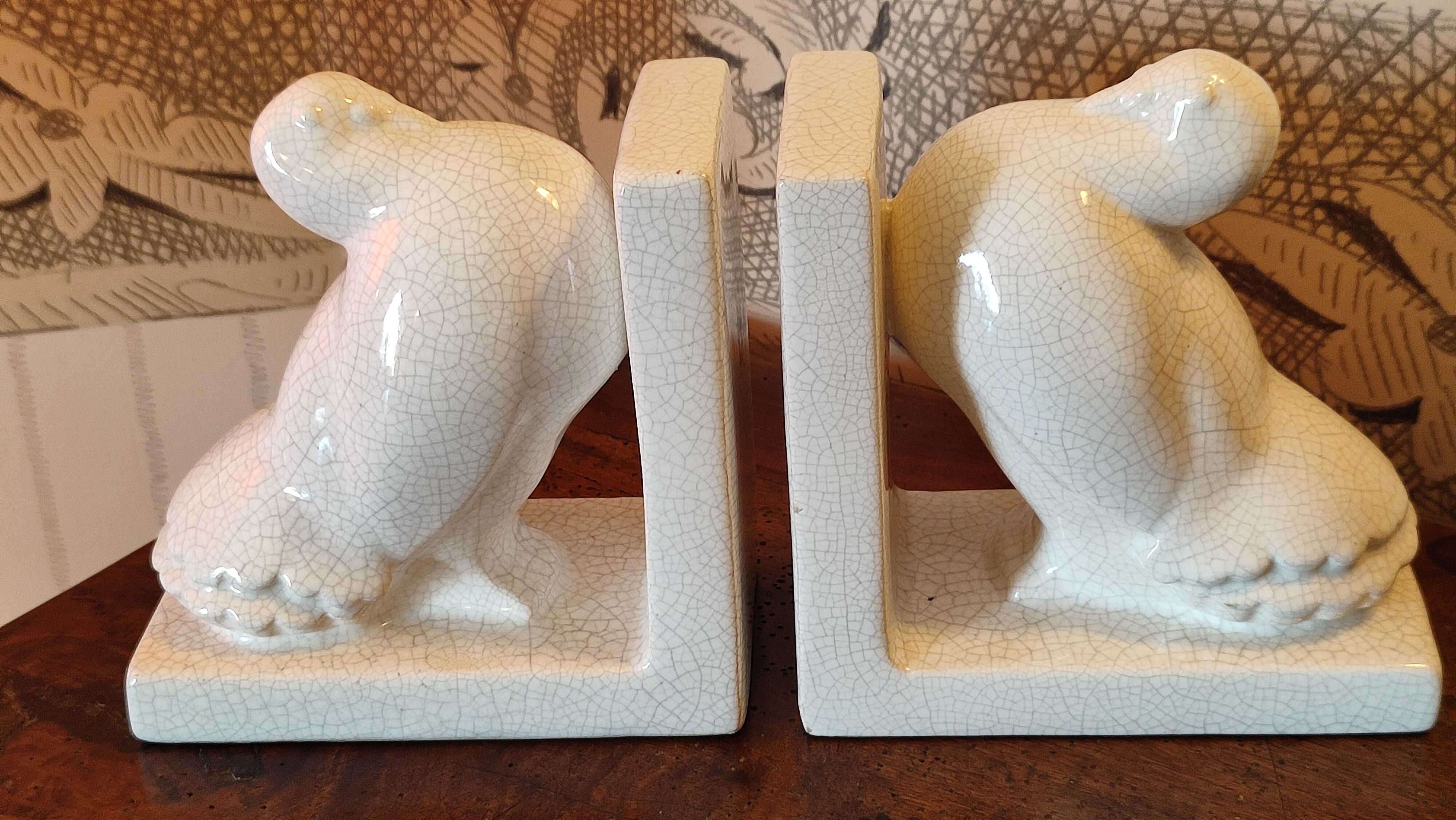 Pair of greenhouse art-deco books about cracked earthenware bird