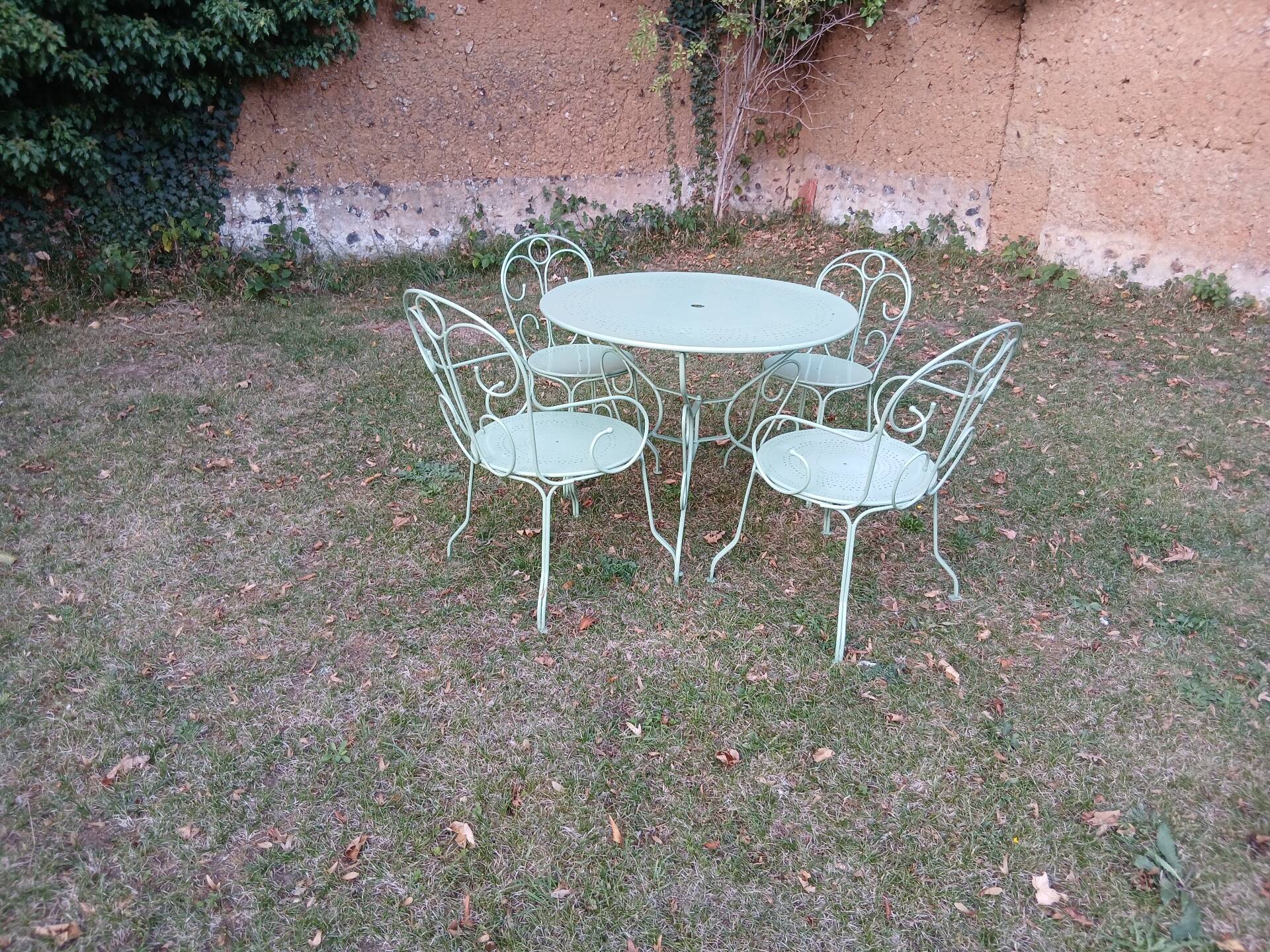 Garden furniture set with 1 table, 2 armchairs, and 2 chairs in antique green wrought iron.