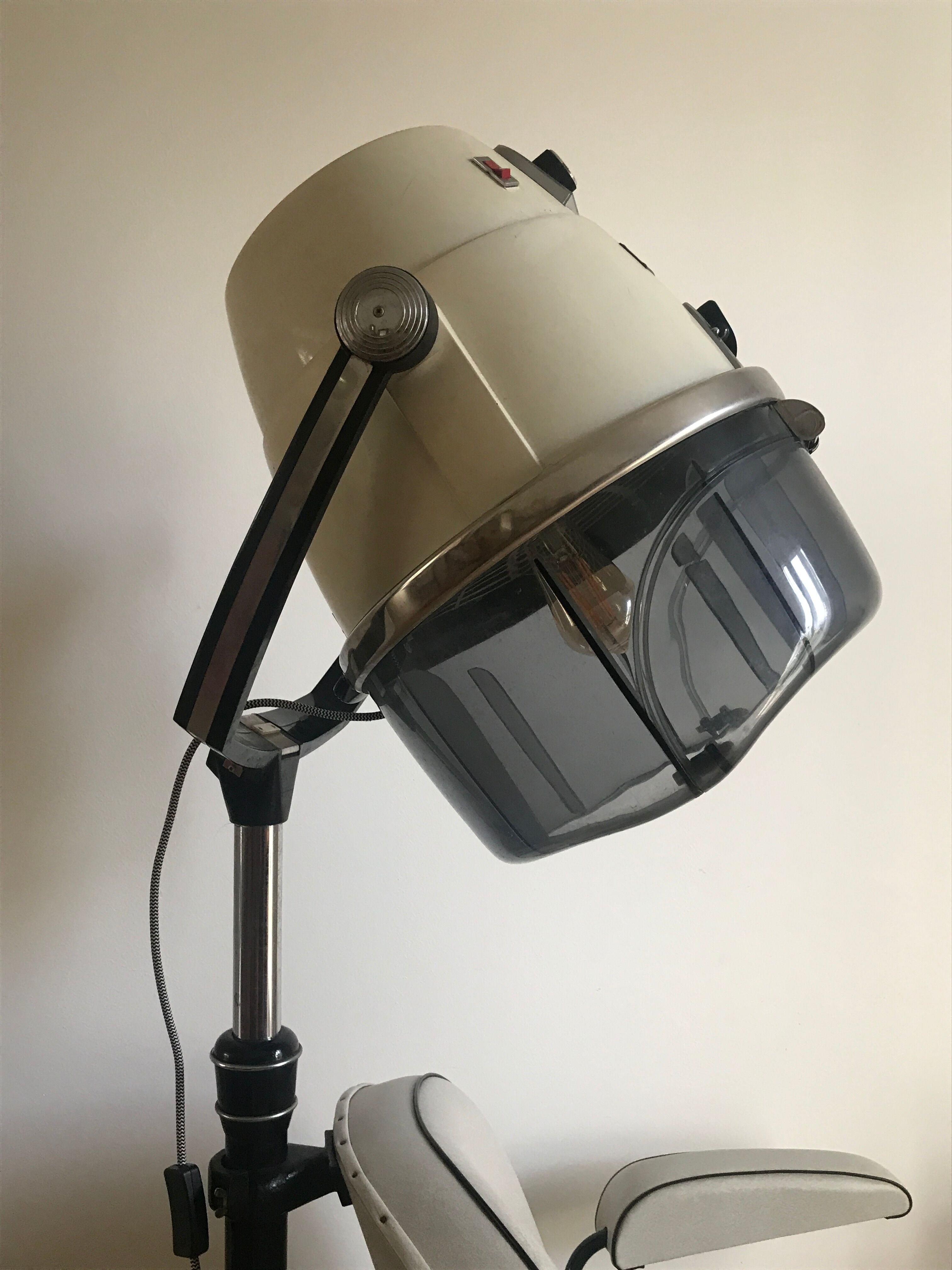 Vintage hairdresser's armchair with helmet transformed into a lamp