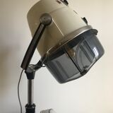 Vintage hairdresser's armchair with helmet transformed into a lamp