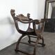 Curule chair Dagobert in carved walnut with lion heads.