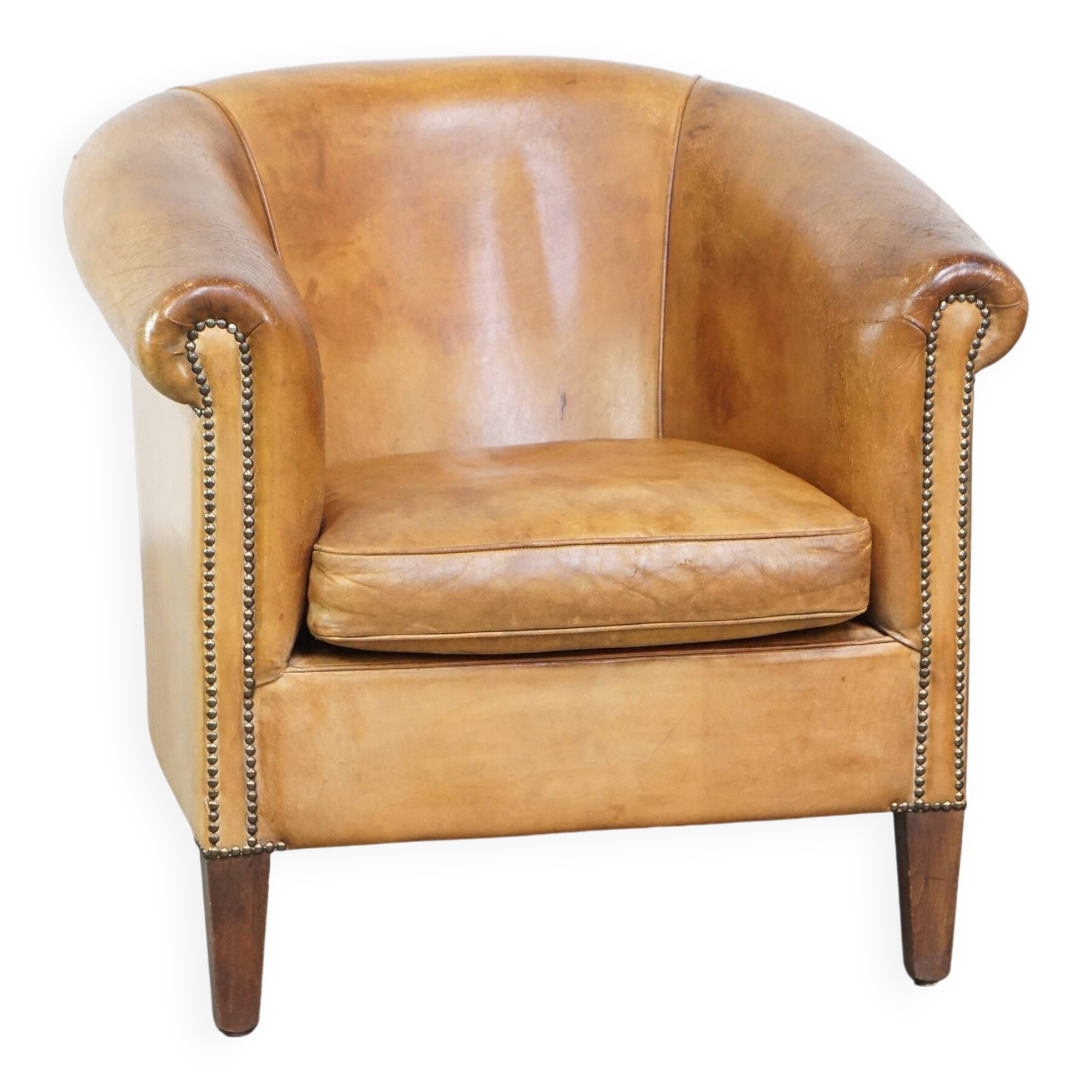 Comfortable, cozy, warm colored sheepskin club chair finished with decorative nails