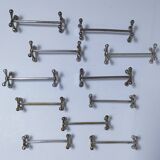 Eleven 70s design metal "crosshair" knife holders