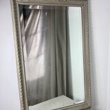 Large antique beveled mirror in carved wood painted with floral decoration and