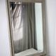 Large antique beveled mirror in carved wood painted with floral decoration and