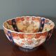 Hand-painted Imari porcelain bowl with an elegant scalloped rim