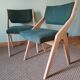 Scandinavian green chairs with tapered legs.