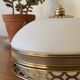 Pair of antique half-spherical ceiling sconces in white glass and brass.