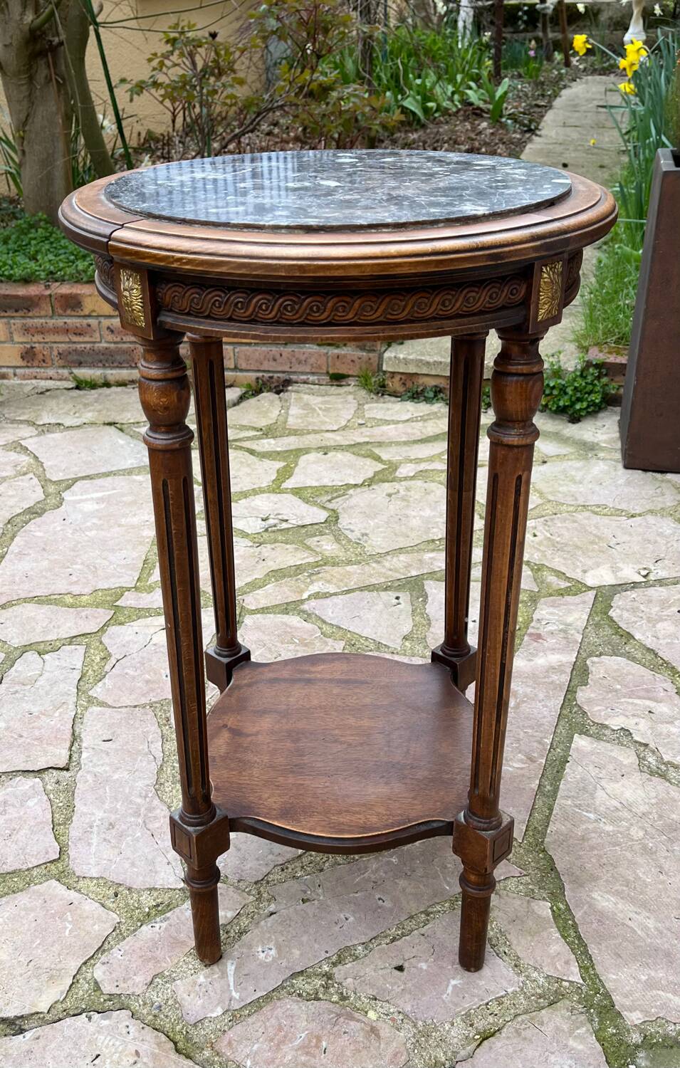 Old wooden pedestal table with marble top