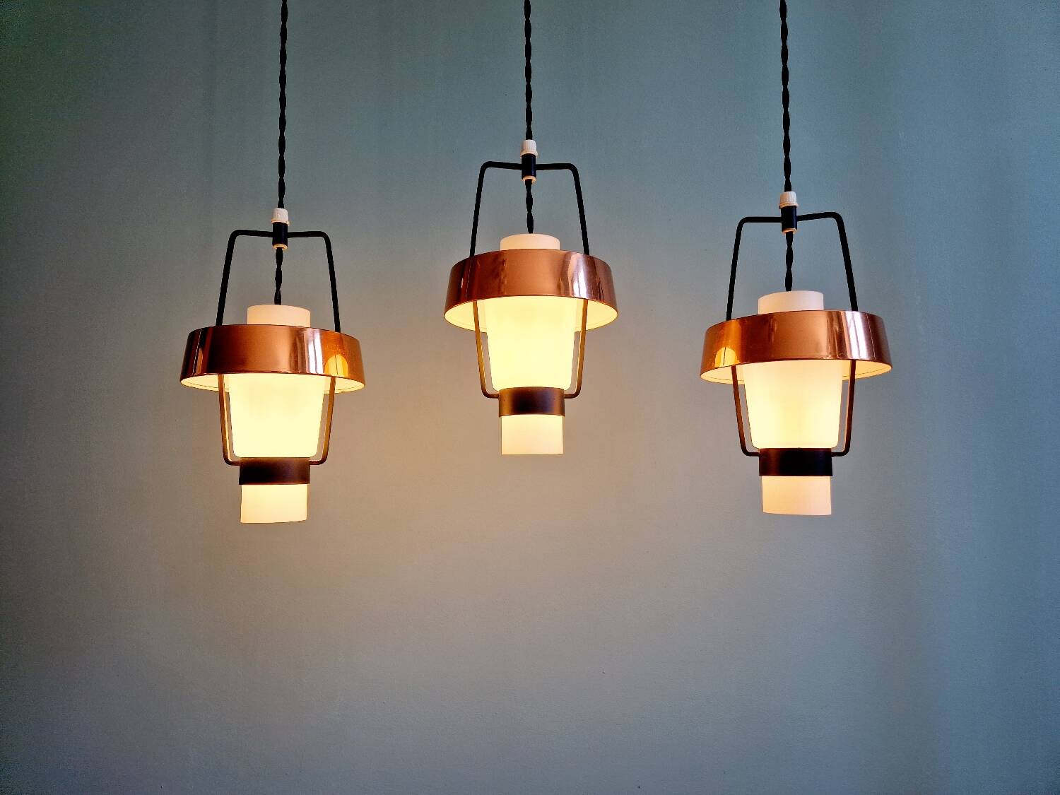 Trio of Scandinavian pendant lights in opaline and copper metal, 1960s