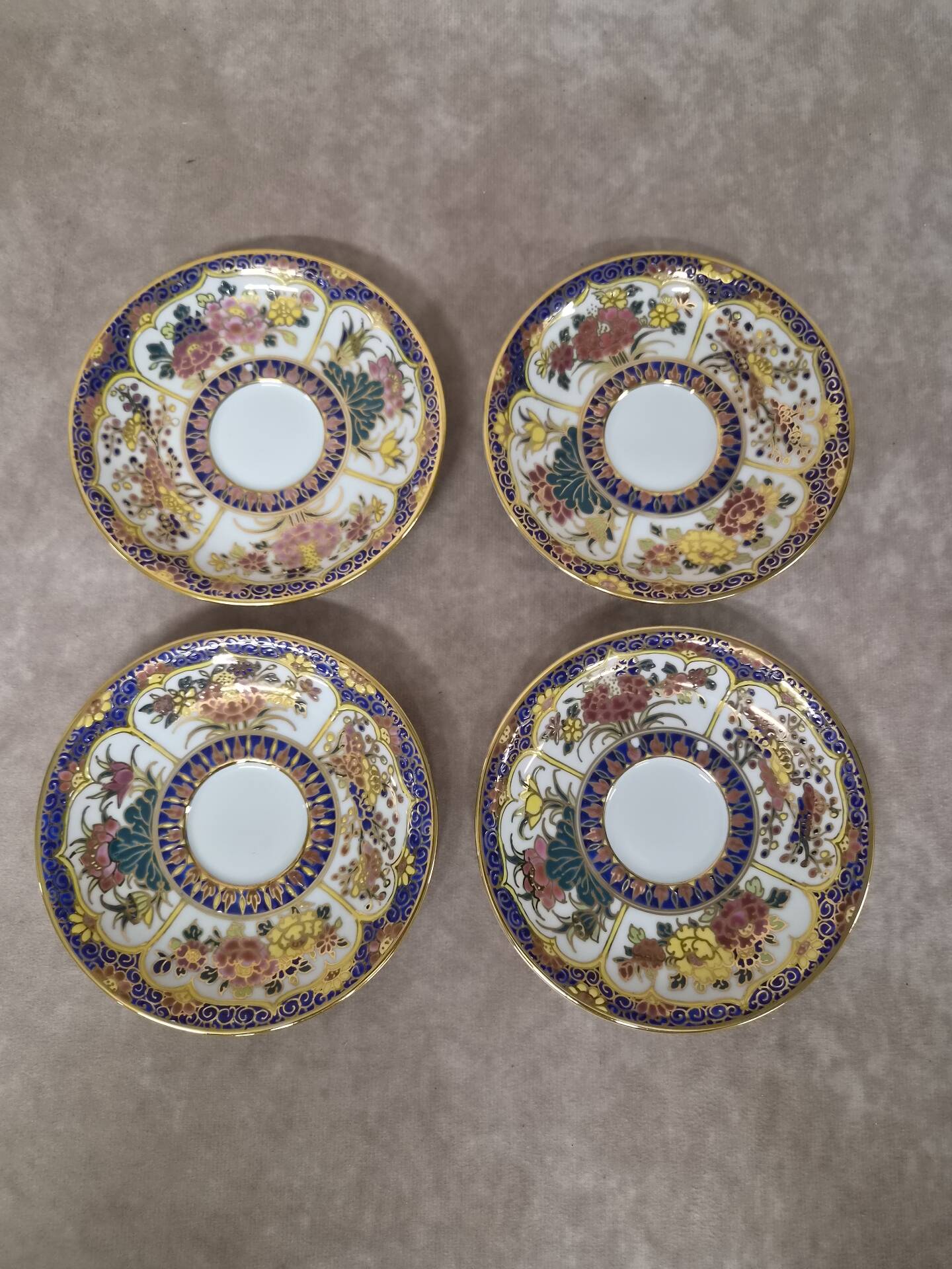 Set of 4 hand-painted saucers from Thailand – Polychrome floral decoration and gilding.