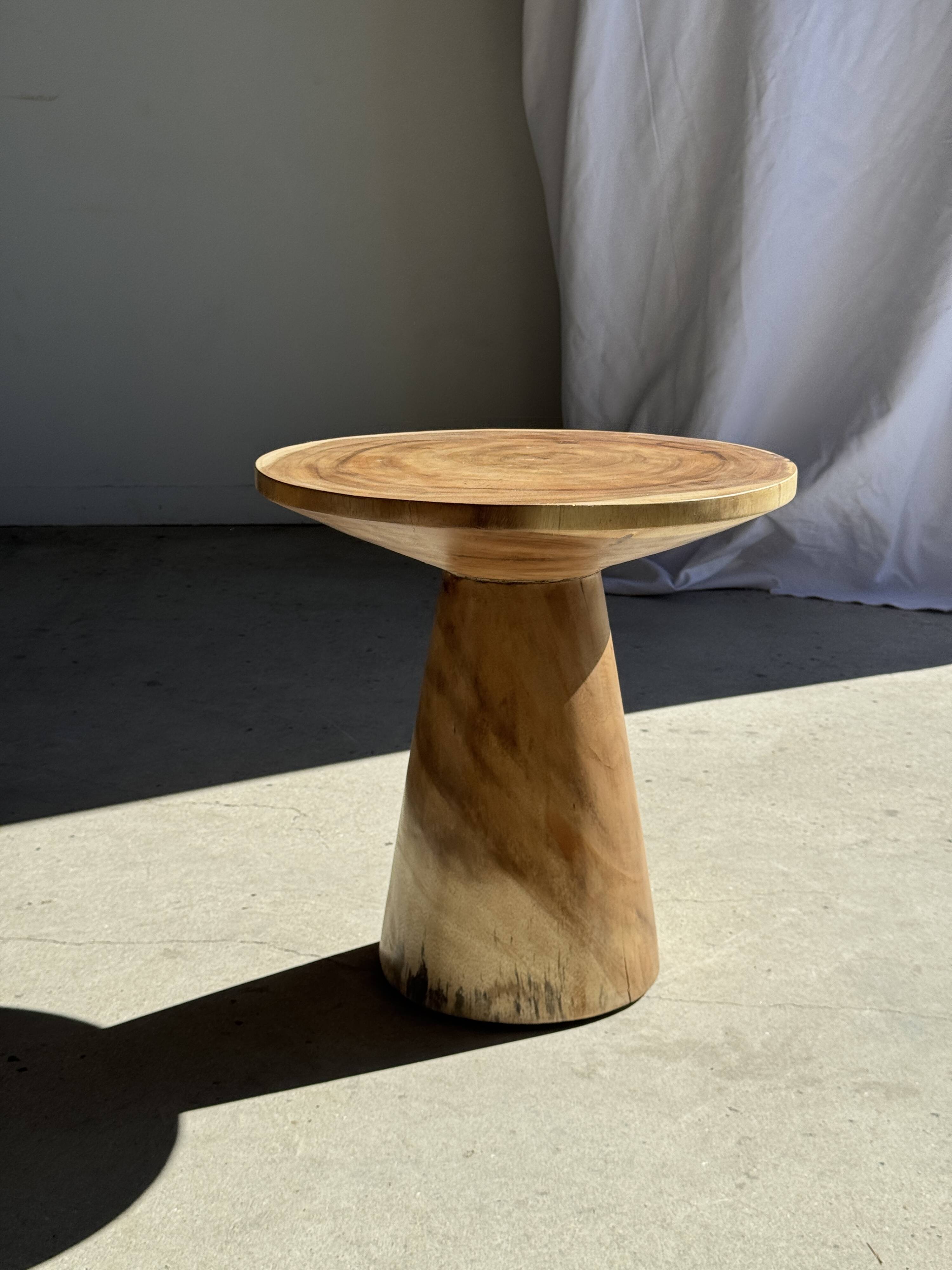 Natural solid suar side table (monoxyle) with a minimal conical base.