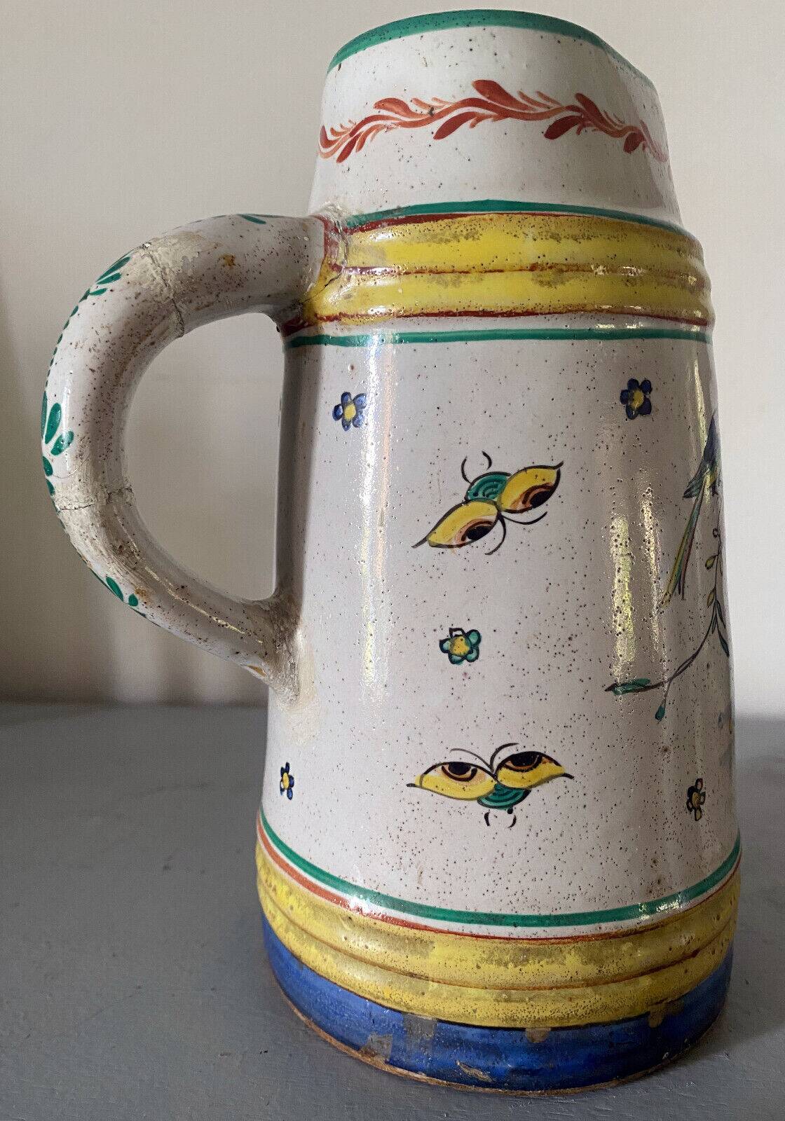 Old ceramic pitcher (18th century?) decorated with polychrome exotic birds