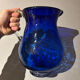 Vintage cobalt blue blown glass jug with a transparent handle.