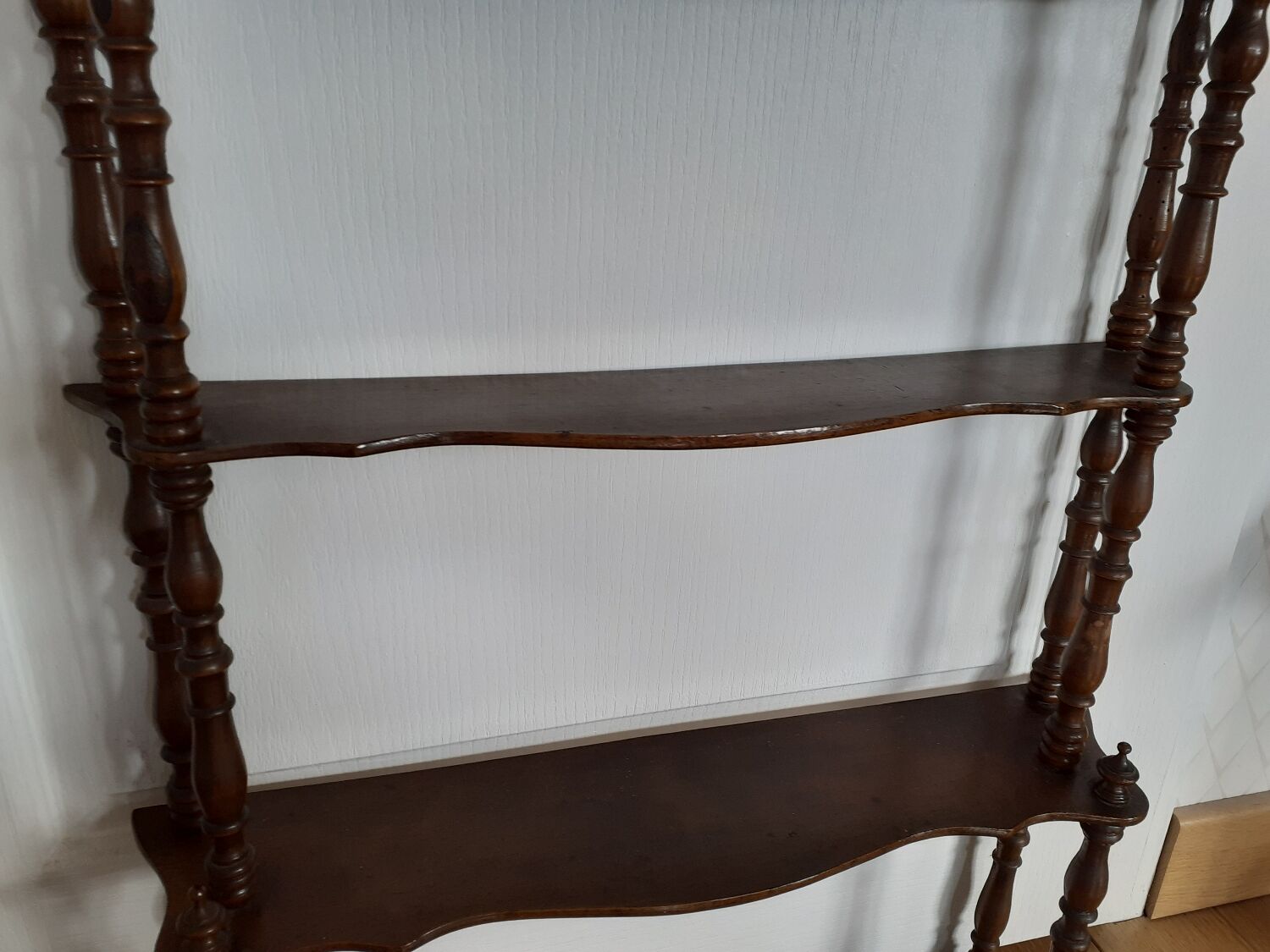 Turned wooden wall shelf