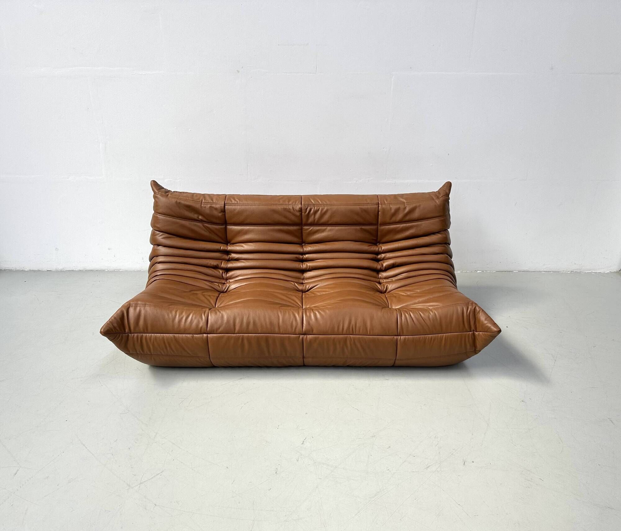 Togo 3-seater in Cognac leather designed by Michel Ducaroy for Ligne Roset.