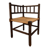 Rush seat chair by the fireplace with beaded wood.